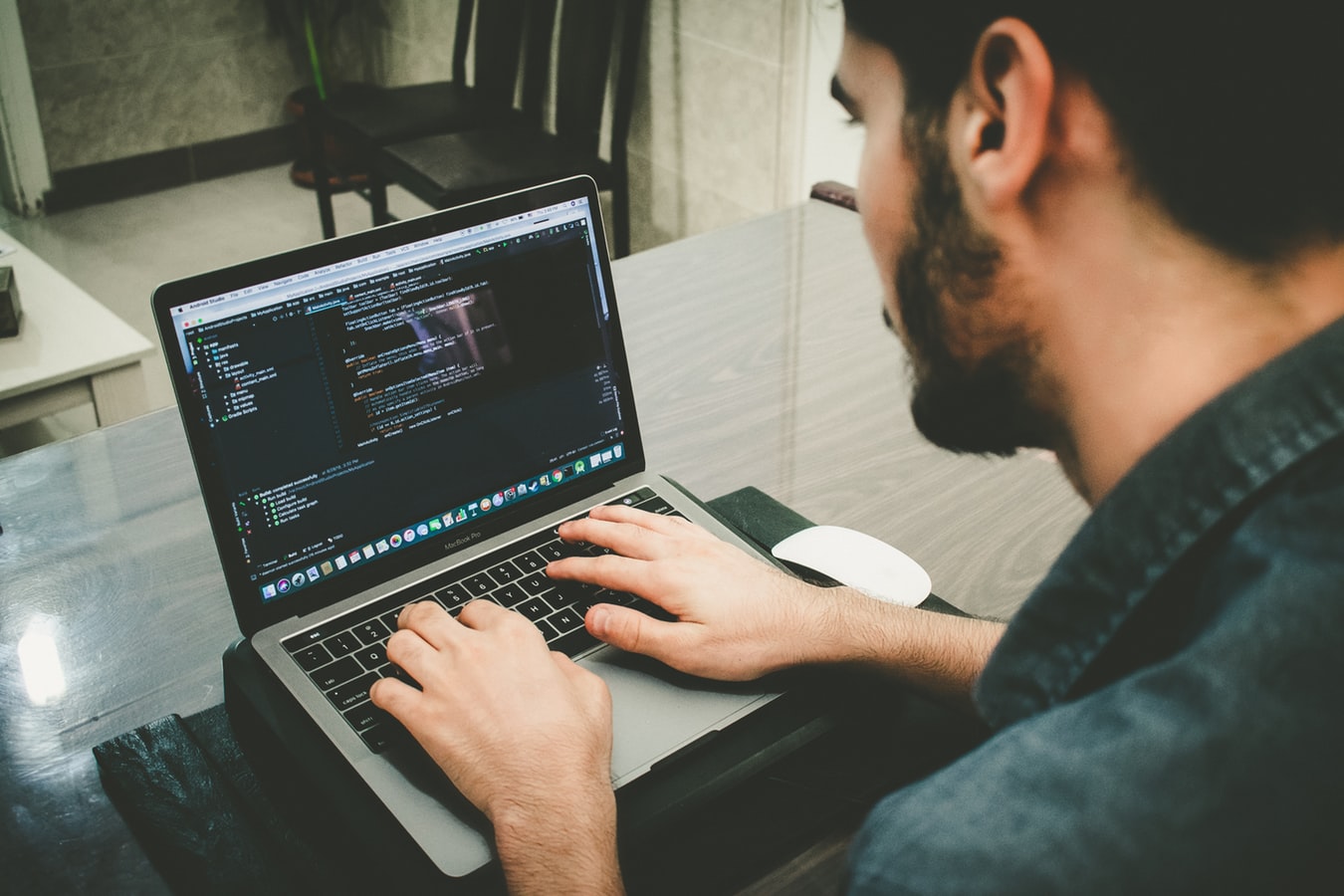 Technical writer working at a desk with notes and a laptop